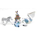 A Goebel pelican, 23cms high; together with a stylised Goebel cat; a Goebel stylised cat; a