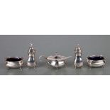 An Edwardian five-piece silver condiment set, Chester 1909, with associated mustard spoon, 171g (