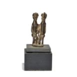 A Lobi couple pendant, Burkina Faso brass of a seated male and female, with a loop attachment to the