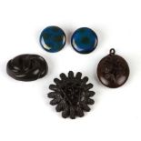 A Vulcanite pendant; together with two similar brooches and a pair of C H Barum pottery buttons.