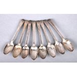 A set of eight George III silver teaspoons with scallop bowls, initialled, lion passant and makers