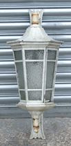 A painted cast iron wall mounted outside or hall lantern of hexagonal tapering form, 64cms high.