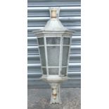A painted cast iron wall mounted outside or hall lantern of hexagonal tapering form, 64cms high.