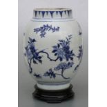 A Chinese blue & white vase decorated with scrolling flowering foliage, 25cms high.