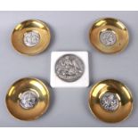 A group of four Greek brass and silver dishes by Ilias Lalaounis, each 12cms diameter; together with