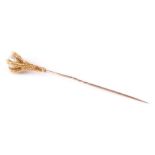 An antique French yellow metal (tests as 18ct gold) stick pin in the form of an eagles claw clasping