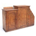 An early 20th century oak table top office letters box, the stepped cupboards with letters slot tops