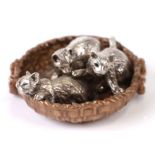 An 800 grade silver and silver gilt model of kittens in a basket, 3.5cms diameter, 31g.