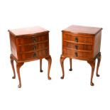 A pair of bowfronted walnut bedside cabinets with three long drawers, on cabriole legs, 46cms