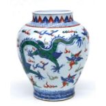 A Chinese Wucai baluster vase decorated with dragons amongst clouds chasing a flaming pearl, 29cms