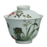 A Chinese cup and cover decorated with bats and foliage, 9cms diameter.