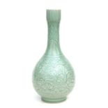 A Chinese celadon glaze bottle vase decorated with stylised dragons amongst stylised scrolls, four