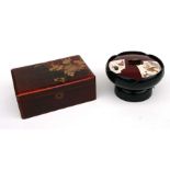 A Japanese red lacquer lidded box, the lid decorated with birds and insects, 23cms wide; together