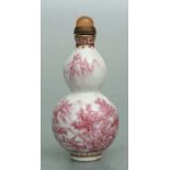 A Chinese pink and white double gourd snuff bottle, four character blue mark to the underside,