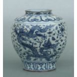 A Chinese blue & white vase decorated with dragons chasing a flaming pearl amongst flowering