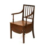 An 18th / 19th century elm country commode chair.