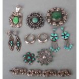 A group of Navajo Native American silver and white metal jewellery, brooches, bracelets and