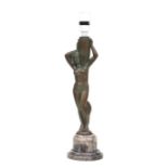 An Art Deco bronzed spelter table lamp in the form of a naked girl carrying an urn, on a marble