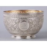 A Victorian silver bowl with repousse decoration and circular cartouche with rampant griffin, London