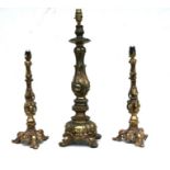 A pair of gilt metal table lamps in the Gothic taste, 41cms high; together with a similar larger