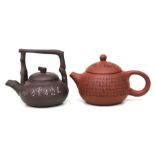 A Chinese Yixing pottery teapot decorated with calligraphy, impressed mark to the underside, 7cms
