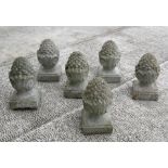 A set of six garden stoneware pineapple finials, each 33cms high (6).