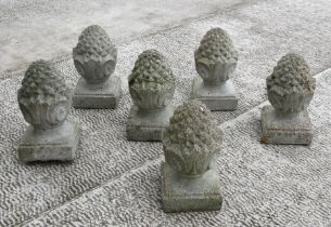 A set of six garden stoneware pineapple finials, each 33cms high (6).