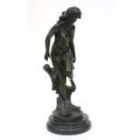 A bronze study of a naked female stood by a tree stump, mounted on a marble plinth, 42cms high.