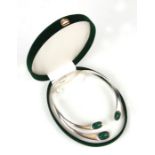 A sterling silver hinged torque necklace set with oval malachite cabochons, 131g.