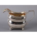 A George III silver milk jug with engraved decoration, initialled, London 1811, 10cms high, 193g.