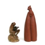 A John Turrell Studio pottery figure of a frog seated on a snail shell holding a camera, 16cms high;