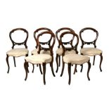 A set of six Victorian walnut balloon back dining chairs with upholstered seats, on cabriole front