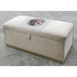 An upholstered pine ottoman with brass casters, 124cms wide.