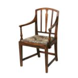 An early 19th century elm elbow chair with drop-in upholstered seat, on square tapering front