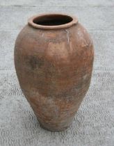 A large Mediterranean terracotta olive jar, 55cms high.