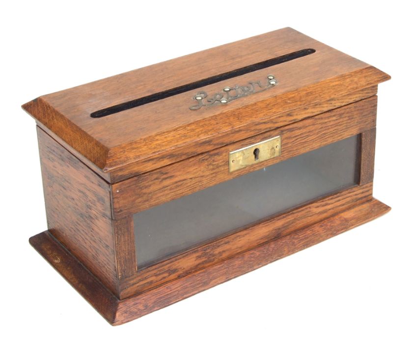 An Edwardian oak table top letters box with applied brass 'Letters' to the top and glazed panel to