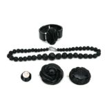 A quantity of antique Whitby jet items to include a necklace, bracelet and brooches.
