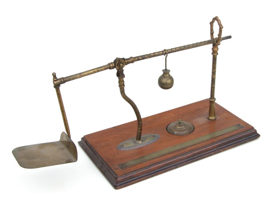 An unusual set of Victorian De Grove & Co. brass postal scales on a mahogany base, 41cms wide.