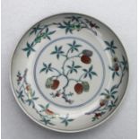 A small Chinese Ducai saucer dish decorated with flowering fruit and foliage, blue seal mark to