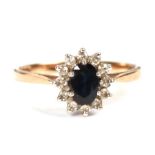 A 9ct gold diamond and sapphire cluster ring, approx UK size 'P', 2.1g.