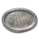 A large oval Persian tinned copper tray with pierced rim, decorated with figures and animals,