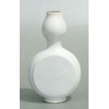 A Chinese white glazed vase of double gourd form, 20cms high.