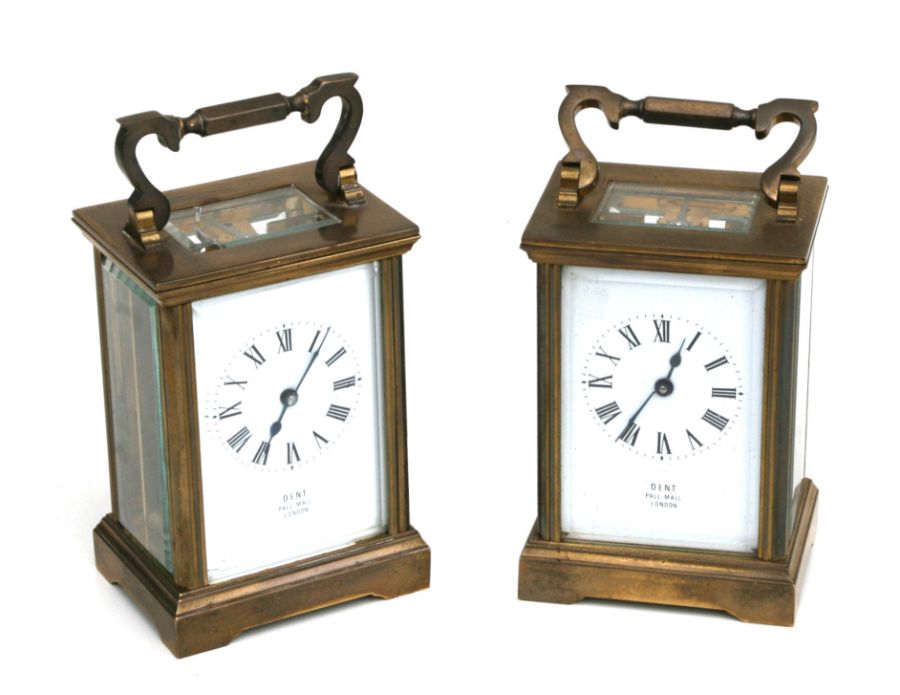 A pair of brass cased carriage time pieces, the white enamel dials with Roman numerals, signed '