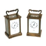 A pair of brass cased carriage time pieces, the white enamel dials with Roman numerals, signed '