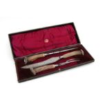 A Thomas Turner & Company antler handled three-piece carving set, cased.