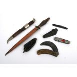A quantity of knives to include military multi bladed, a stiletto, Norwegian hunting knife and a