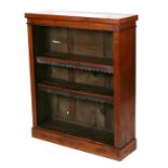 A Victorian walnut open bookcase with two leather trimmed shelves, on a plinth base, 84cms wide.