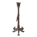 A 19th century bronze candlestick with reeded column and applied lizard, on three lion paw feet,