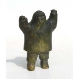 An Inuit carved stone figure depicting a man with outstretched arms, 11cms high.