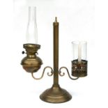 A brass combination oil lamp and candle, 51cms high.